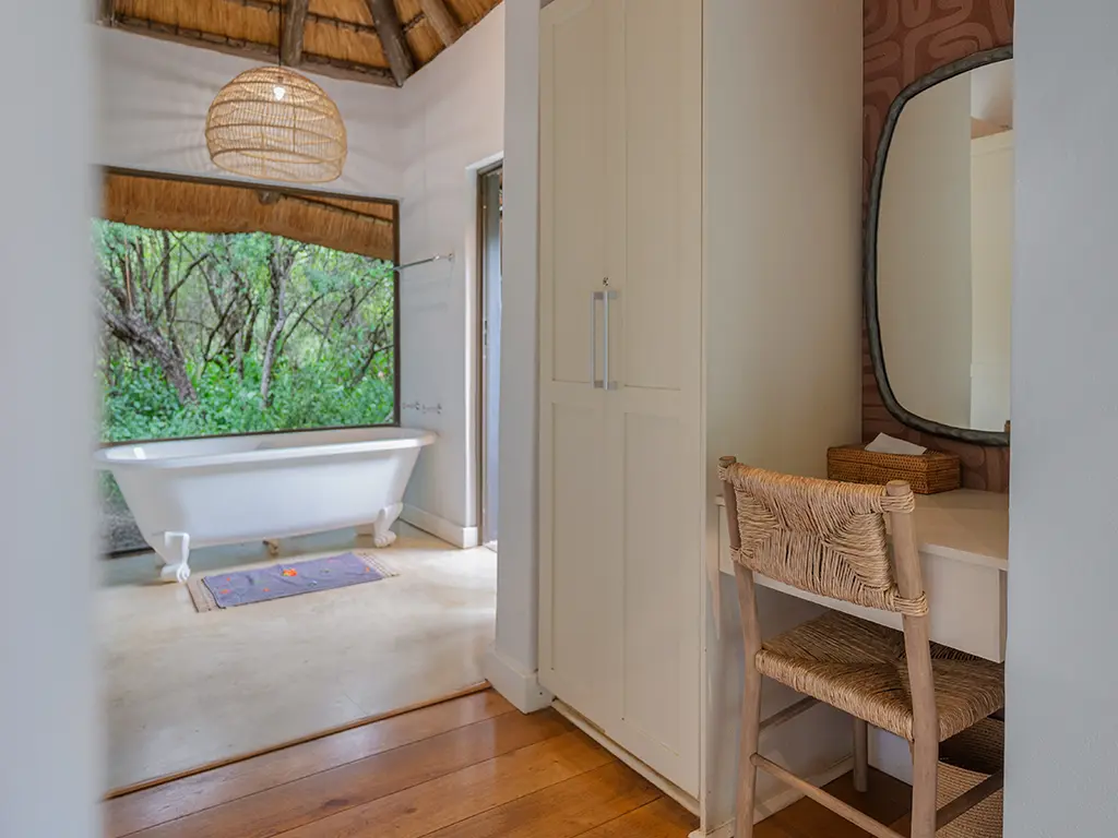 View of one of the bathrooms with a small writing desk in the Homestead, at Rhino River Lodge.